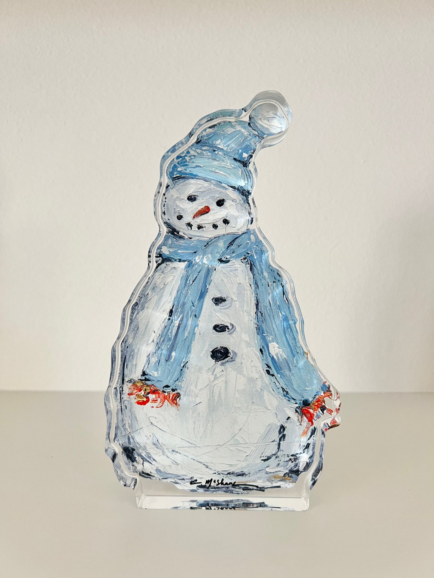 An acrylic snowman with a scarf