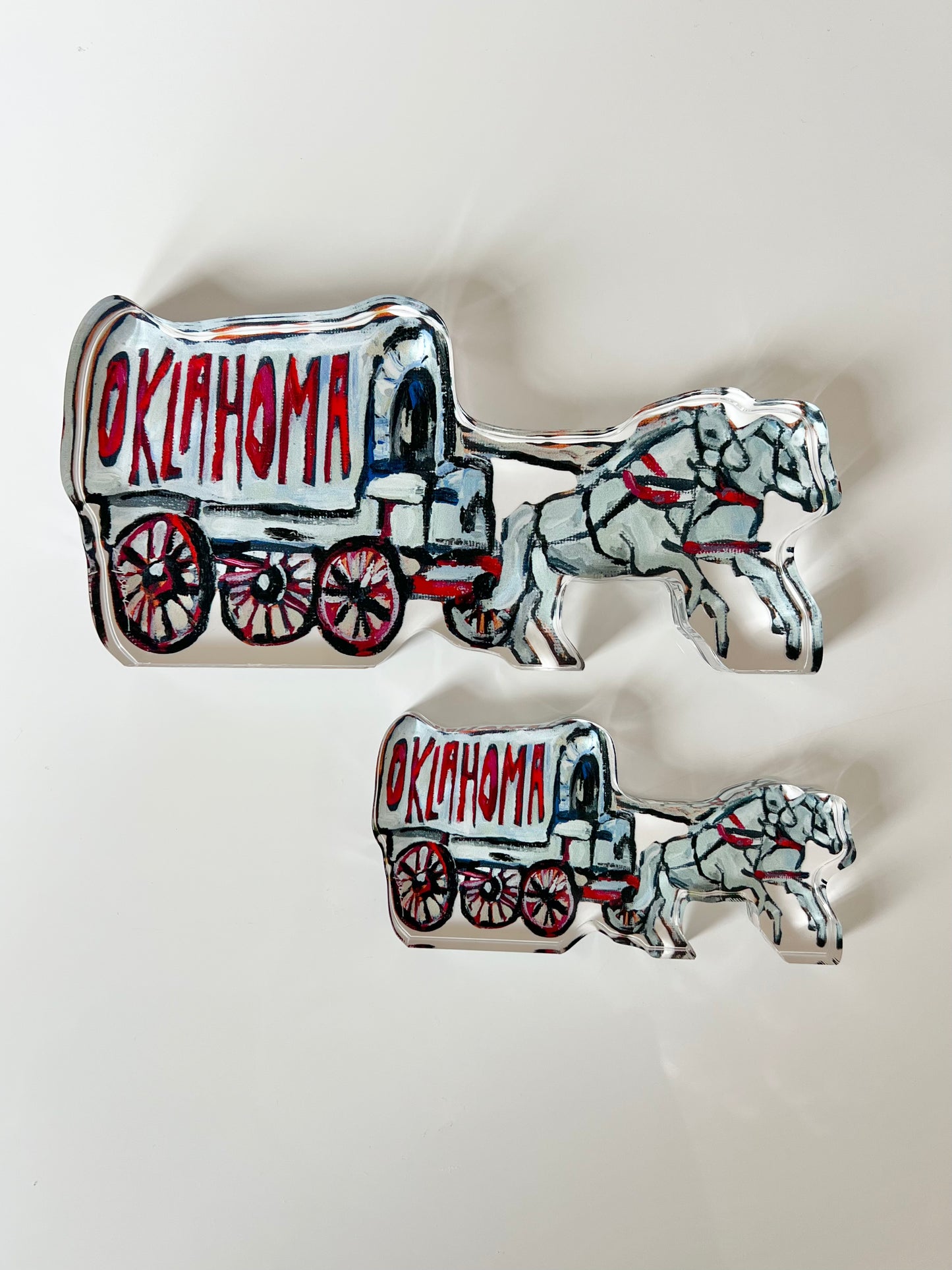 An acrylic tabletop shelfie of a horse and carriage from Oklahoma University.